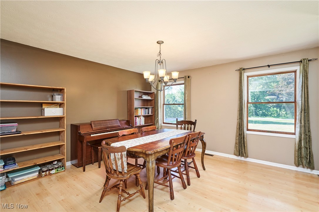 3741 Bassett Road Rootstown, OH 44272 - Photo 8 of 29 Dining space featuring a chandelier and light wood-style floors