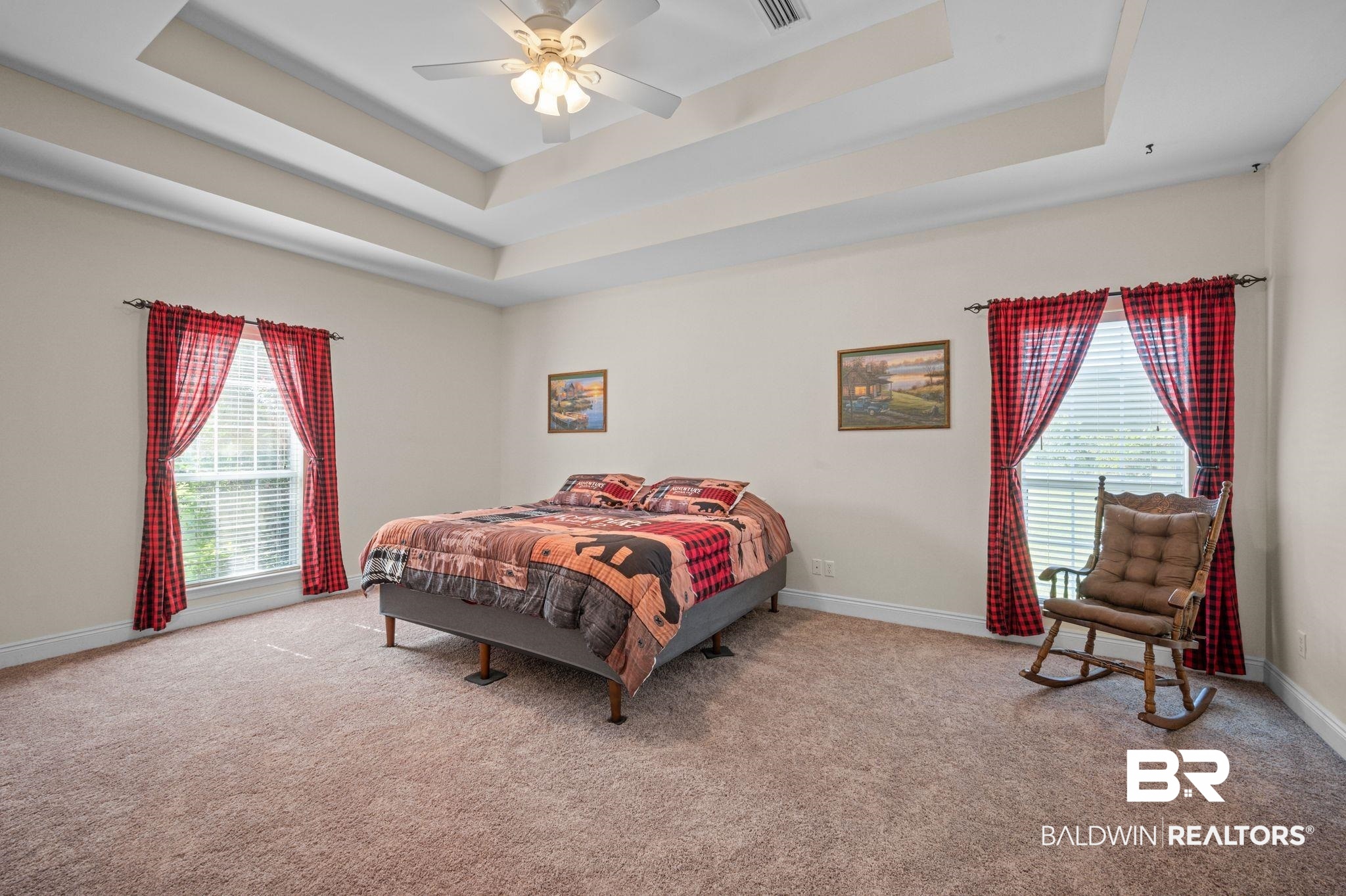 48513 Phillipsville Road Bay Minette, AL 36507 - Photo 20 of 50 Carpeted bedroom with a raised ceiling, multiple windows, and a ceiling fan