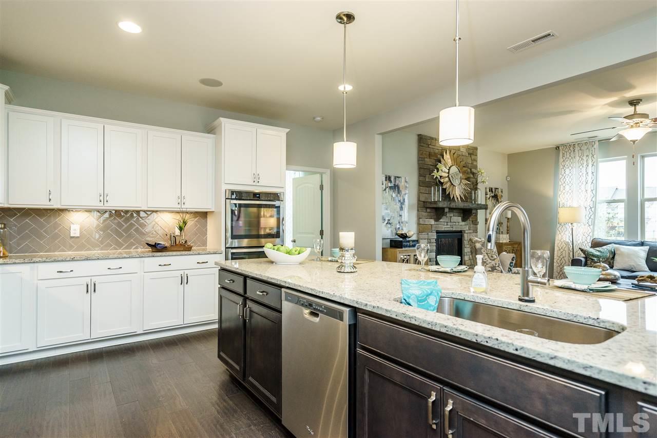 125 Twilight Trail, Unit STONEFIELD Willow Spring, NC 27592 - Photo 12 of 22 a kitchen with sink stove and cabinets