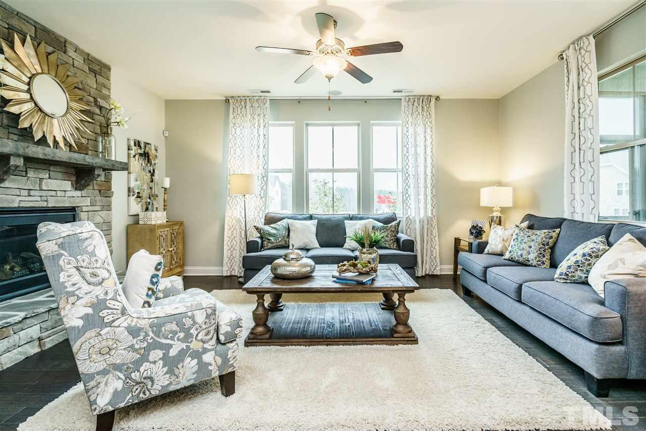 125 Twilight Trail, Unit STONEFIELD Willow Spring, NC 27592 - Photo 13 of 22 a living room with furniture fireplace and a large window