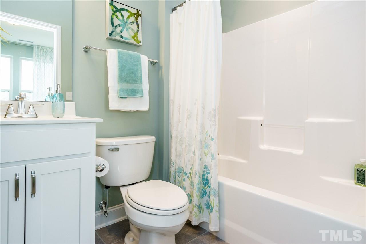 125 Twilight Trail, Unit STONEFIELD Willow Spring, NC 27592 - Photo 16 of 22 a white toilet sitting next to a bath tub