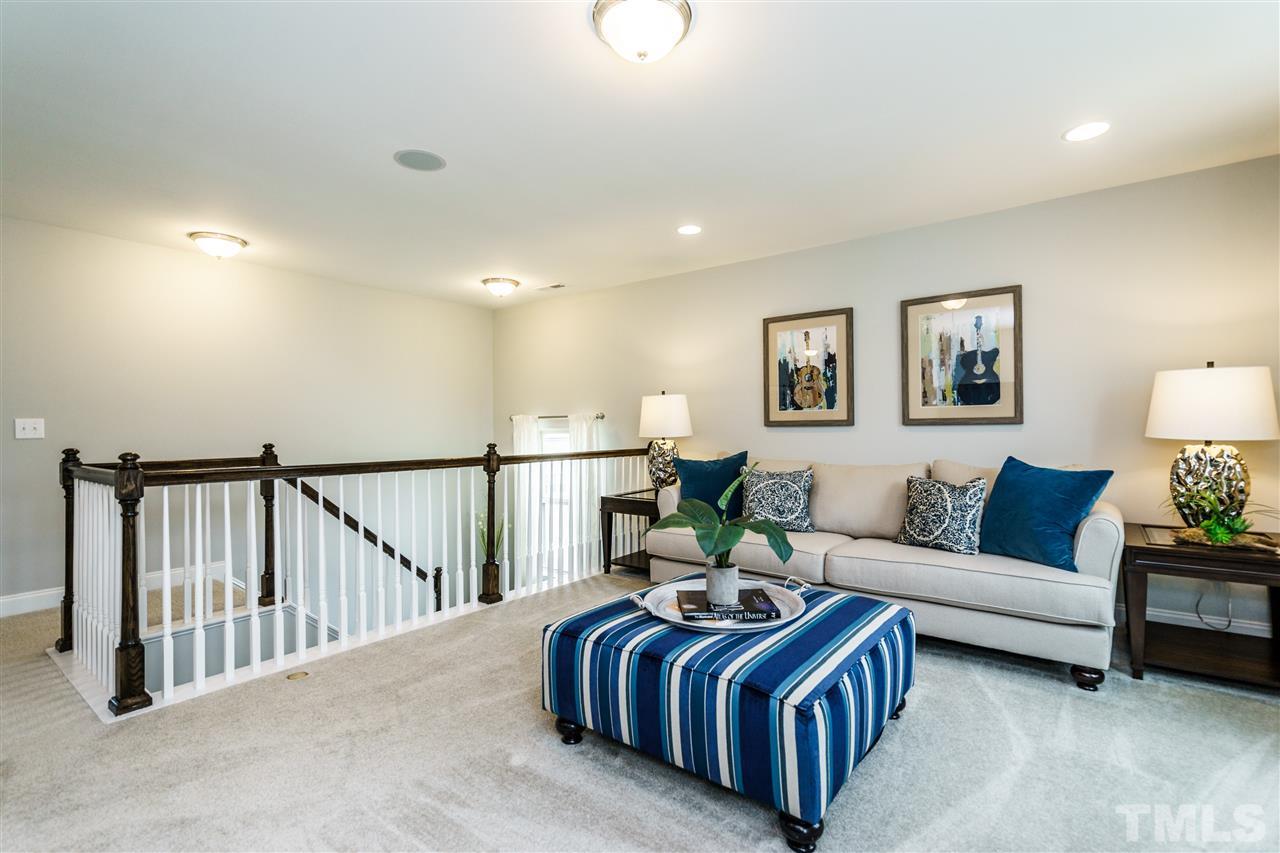 125 Twilight Trail, Unit STONEFIELD Willow Spring, NC 27592 - Photo 17 of 22 a living room with furniture flowerpot and a window