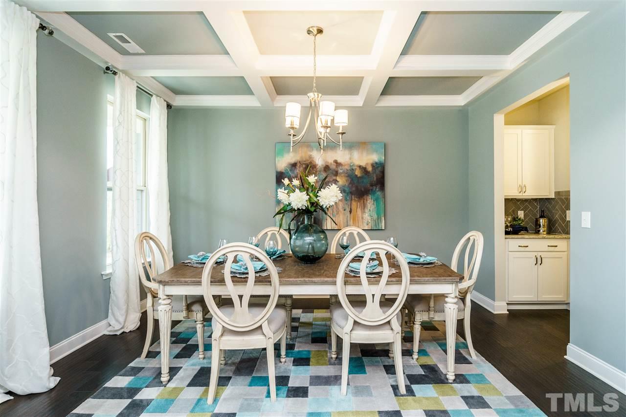 125 Twilight Trail, Unit STONEFIELD Willow Spring, NC 27592 - Photo 4 of 22 a view of a dining room with furniture and chandelier