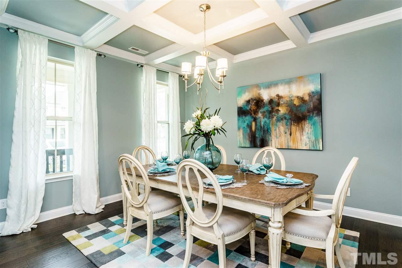 125 Twilight Trail, Unit STONEFIELD Willow Spring, NC 27592 - Photo 5 of 22 a view of a dining room with furniture wooden floor and chandelier