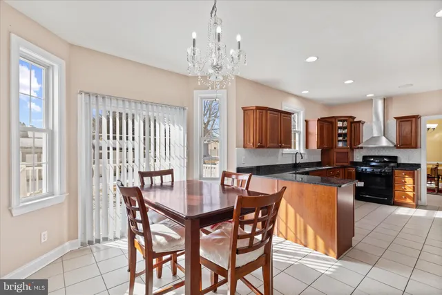 a view of dining room and livingroom with furniture wooden floor windows and a chandelier