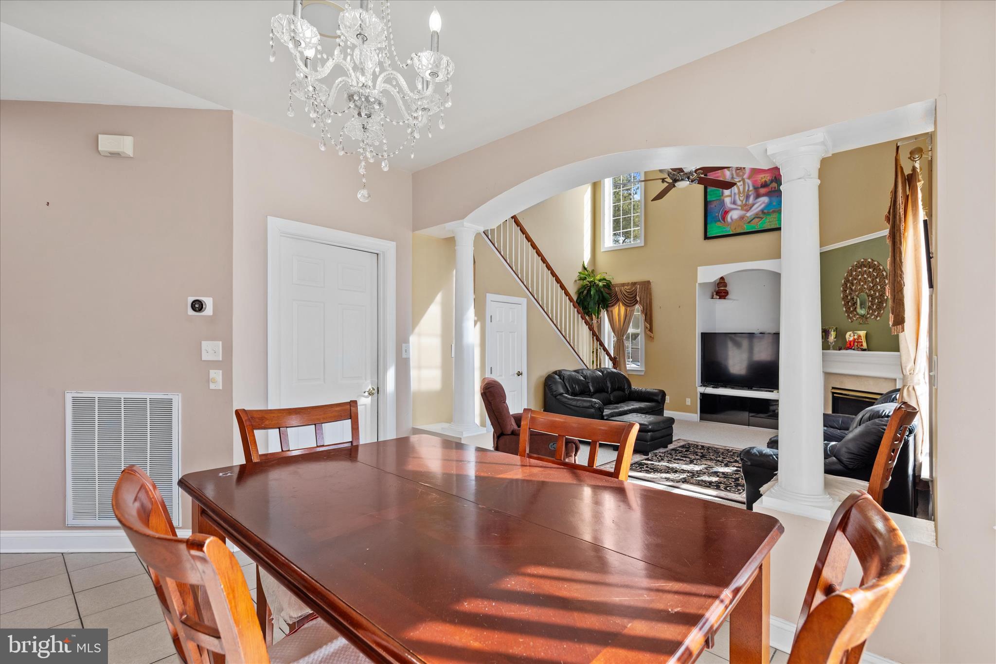 108 Franklin Avenue Berlin, MD 21811 - Photo 14 of 62 a view of dining room and livingroom with furniture wooden floor windows and a chandelier