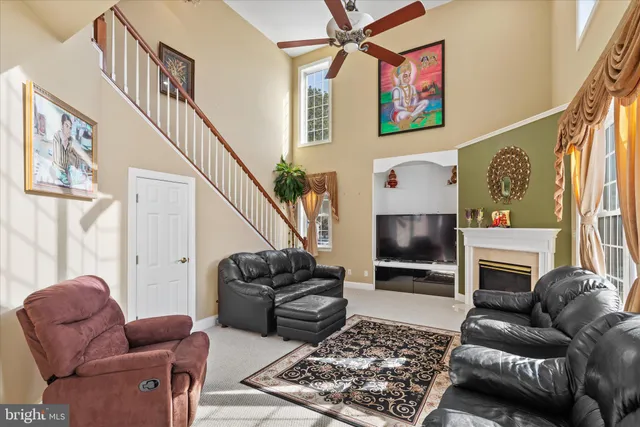 a living room with furniture a fireplace and a large window