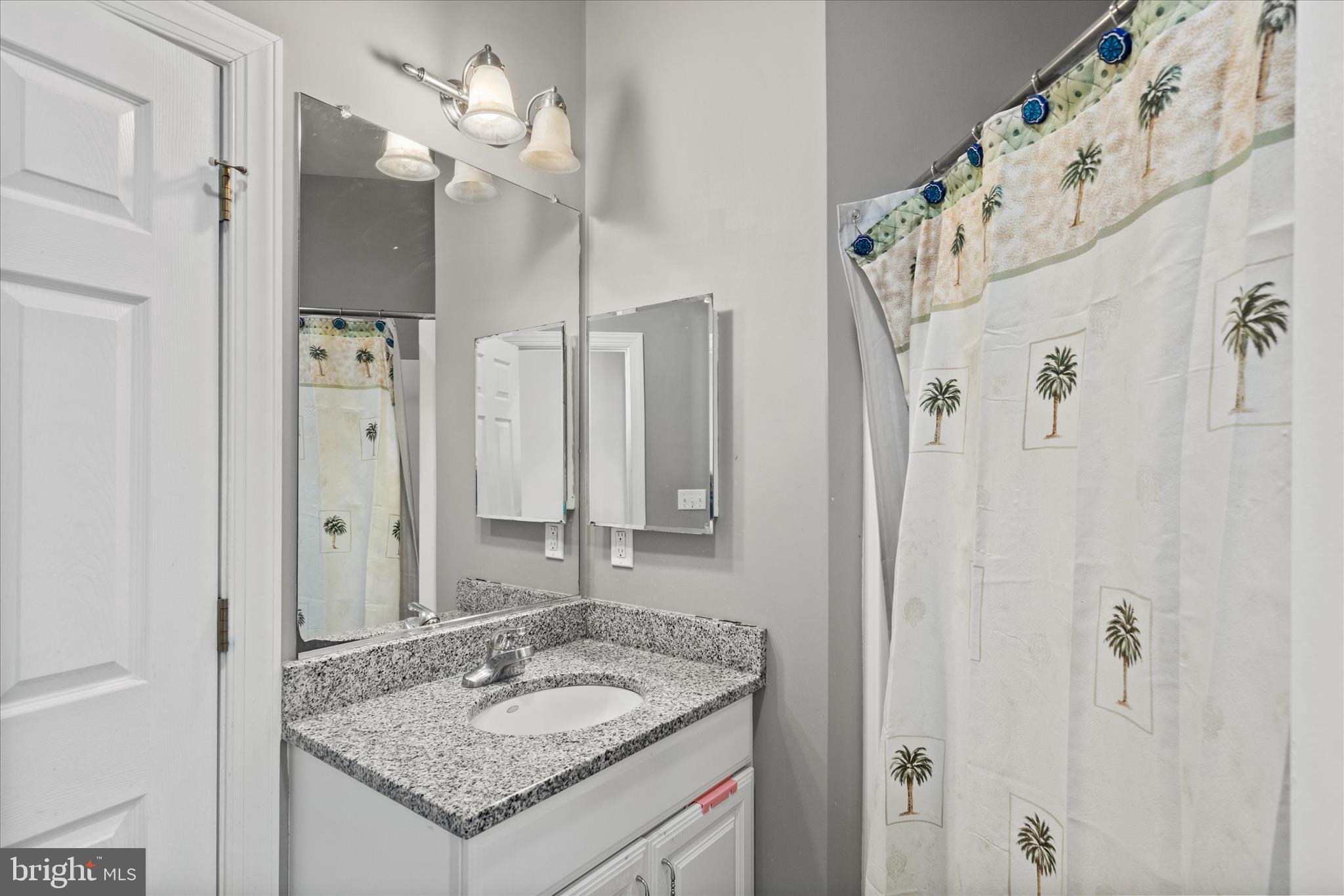 108 Franklin Avenue Berlin, MD 21811 - Photo 35 of 62 a bathroom with a granite countertop sink and a mirror