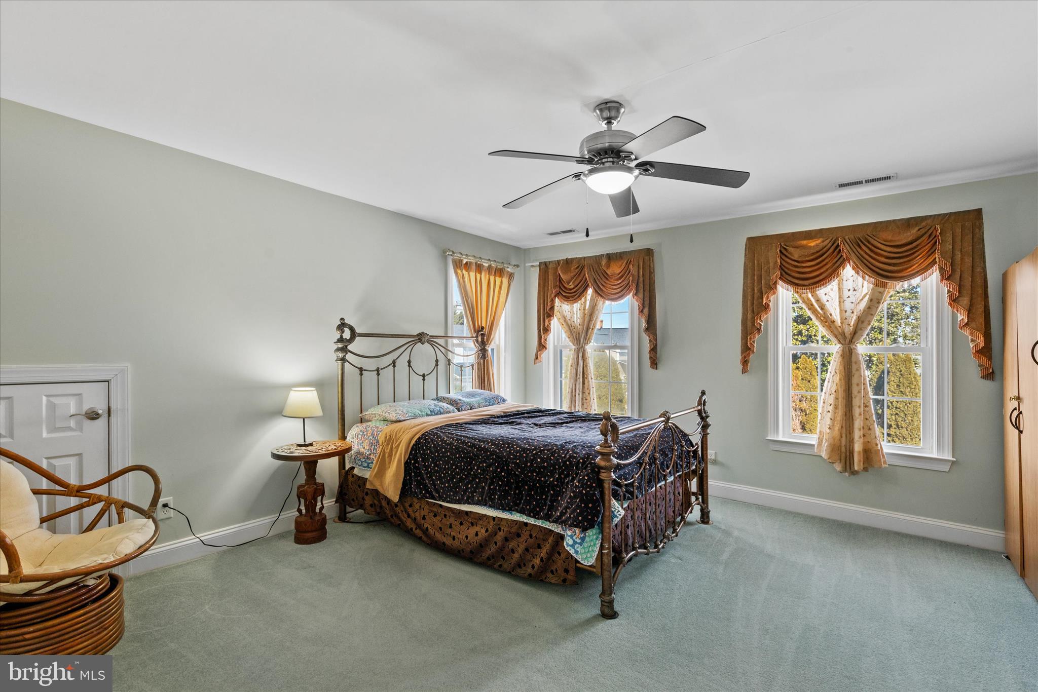 108 Franklin Avenue Berlin, MD 21811 - Photo 47 of 62 a spacious bedroom with a bed a chandelier and a window