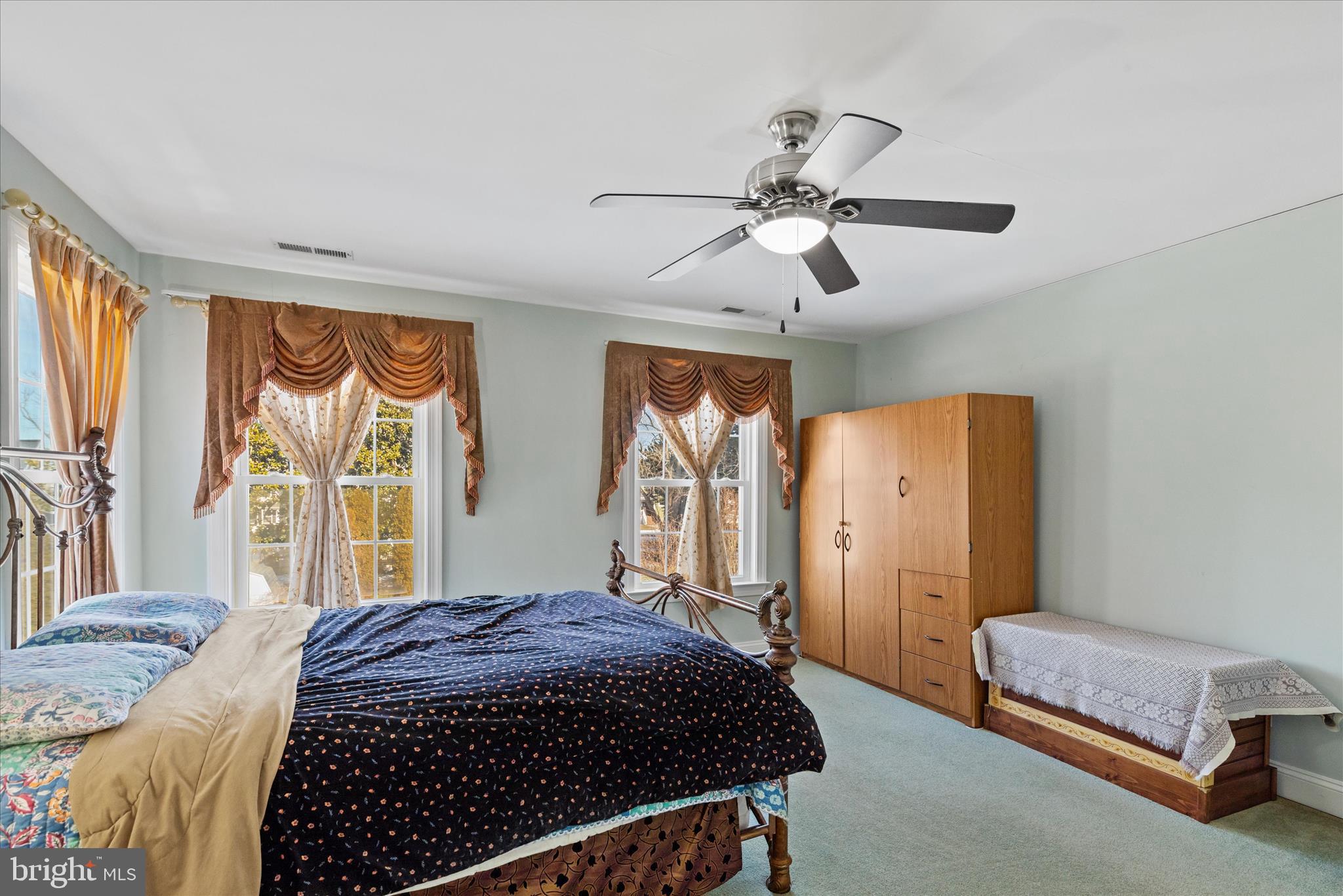 108 Franklin Avenue Berlin, MD 21811 - Photo 48 of 62 a spacious bedroom with a large bed and a chandelier