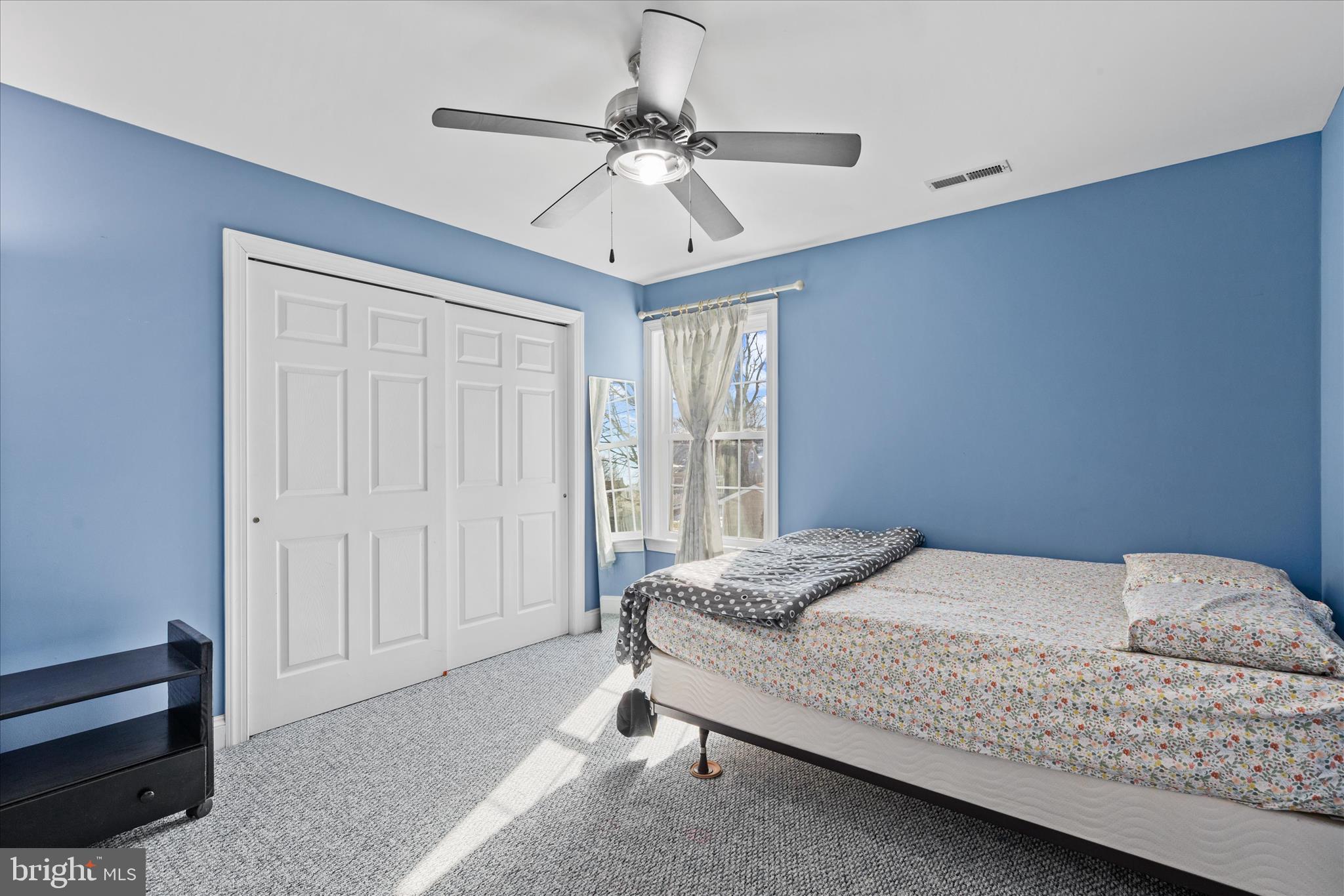 108 Franklin Avenue Berlin, MD 21811 - Photo 53 of 62 a bedroom with a bed and a chandelier