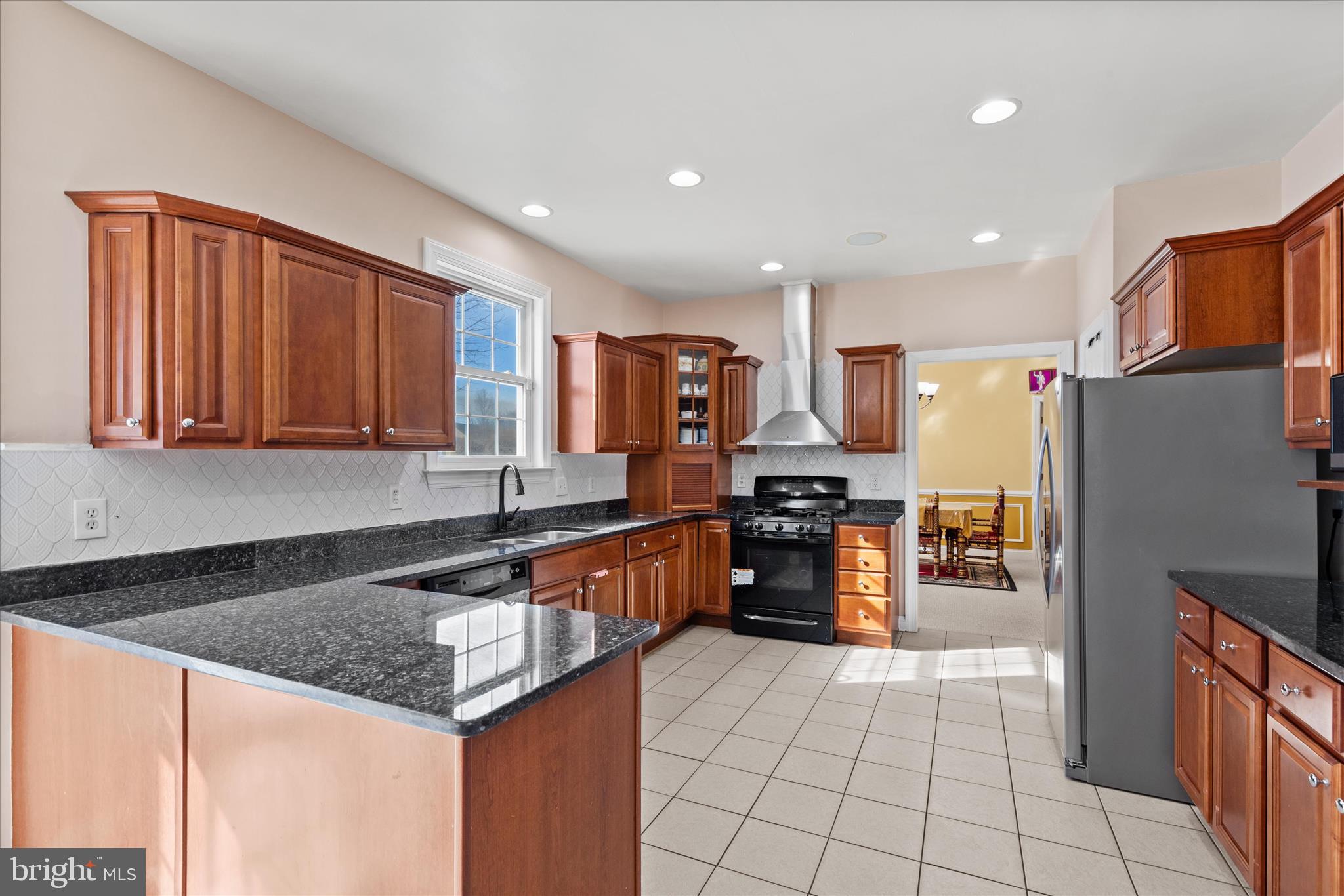 108 Franklin Avenue Berlin, MD 21811 - Photo 6 of 62 a kitchen with stainless steel appliances granite countertop a refrigerator and a stove top oven