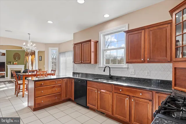 a kitchen with stainless steel appliances granite countertop a refrigerator and microwave
