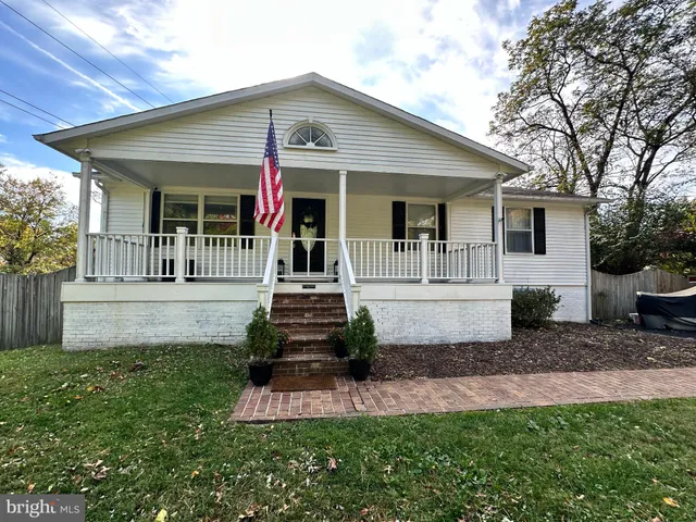 a front view of a house with a garden and porch