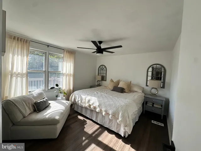 a bedroom with a bed couch and window