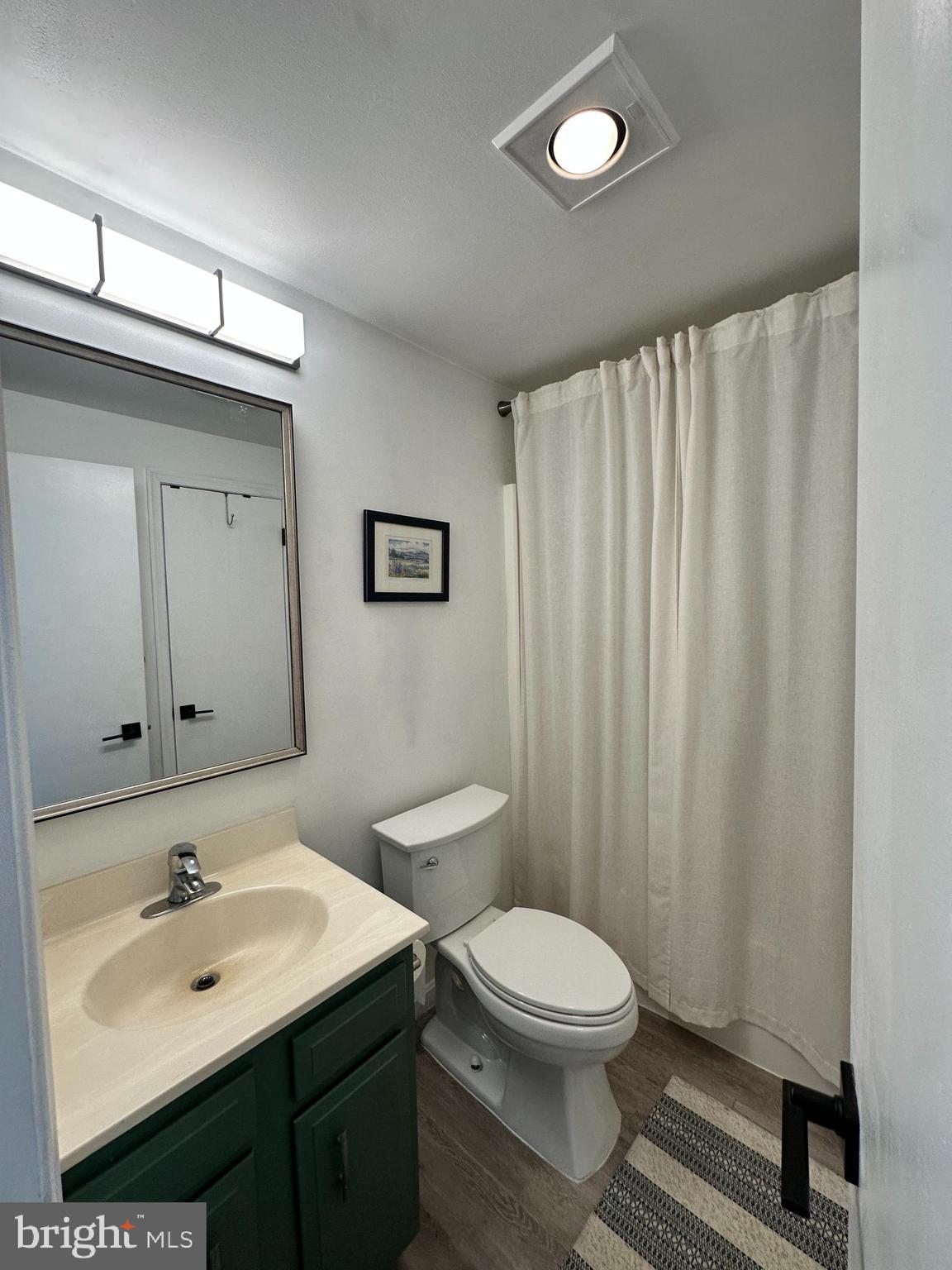 7601 Rudyard Street Falls Church, VA 22043 - Photo 17 of 29 a bathroom with a toilet a sink and mirror