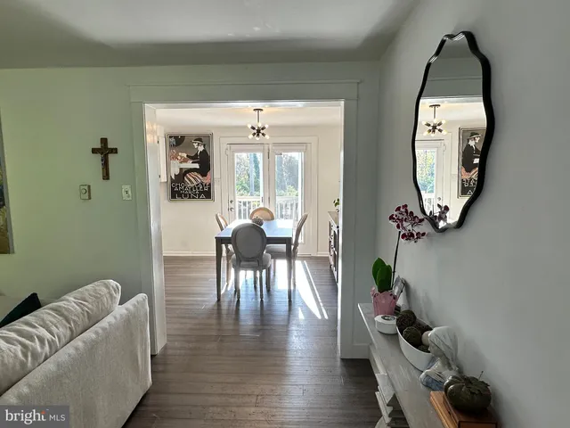 a living room with furniture and a mirror
