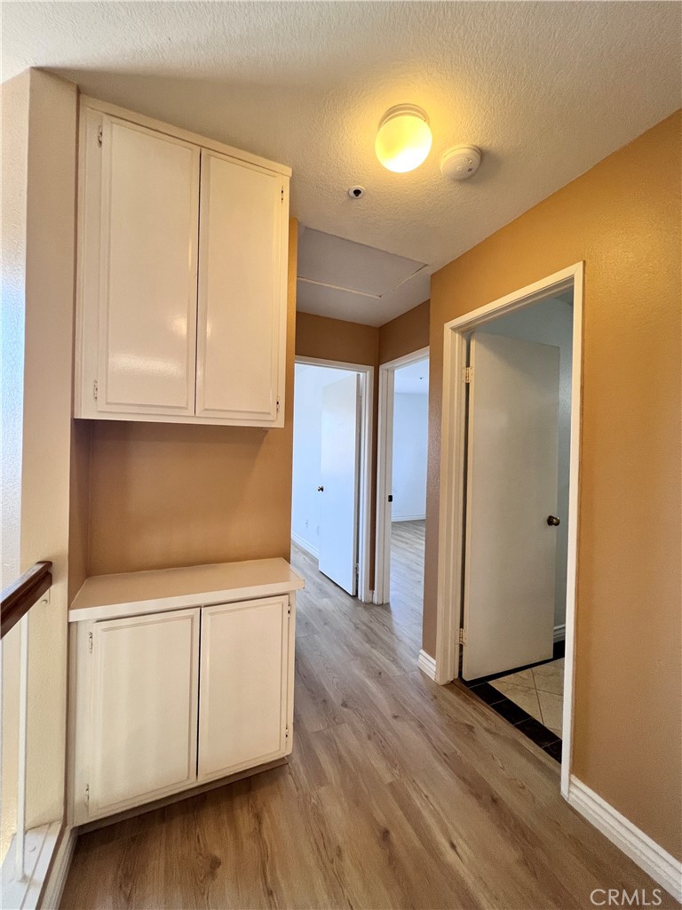 13764 Bay Fontana, CA 92336 - Photo 13 of 18 a kitchen with stainless steel appliances granite countertop a stove a refrigerator and cabinets with wooden floor