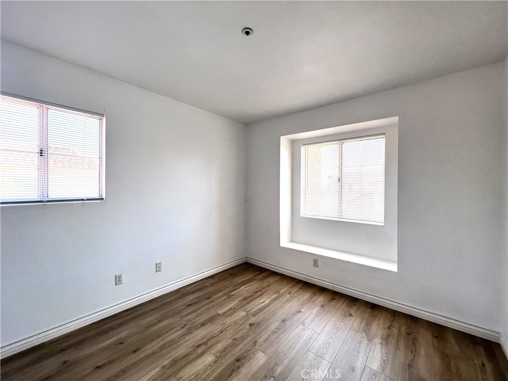 13764 Bay Fontana, CA 92336 - Photo 14 of 18 an empty room with wooden floor and windows