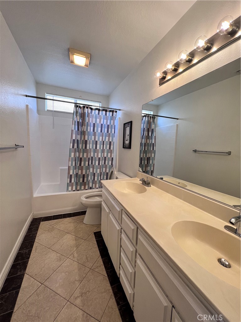 13764 Bay Fontana, CA 92336 - Photo 15 of 18 a bathroom with a granite countertop sink a toilet and shower