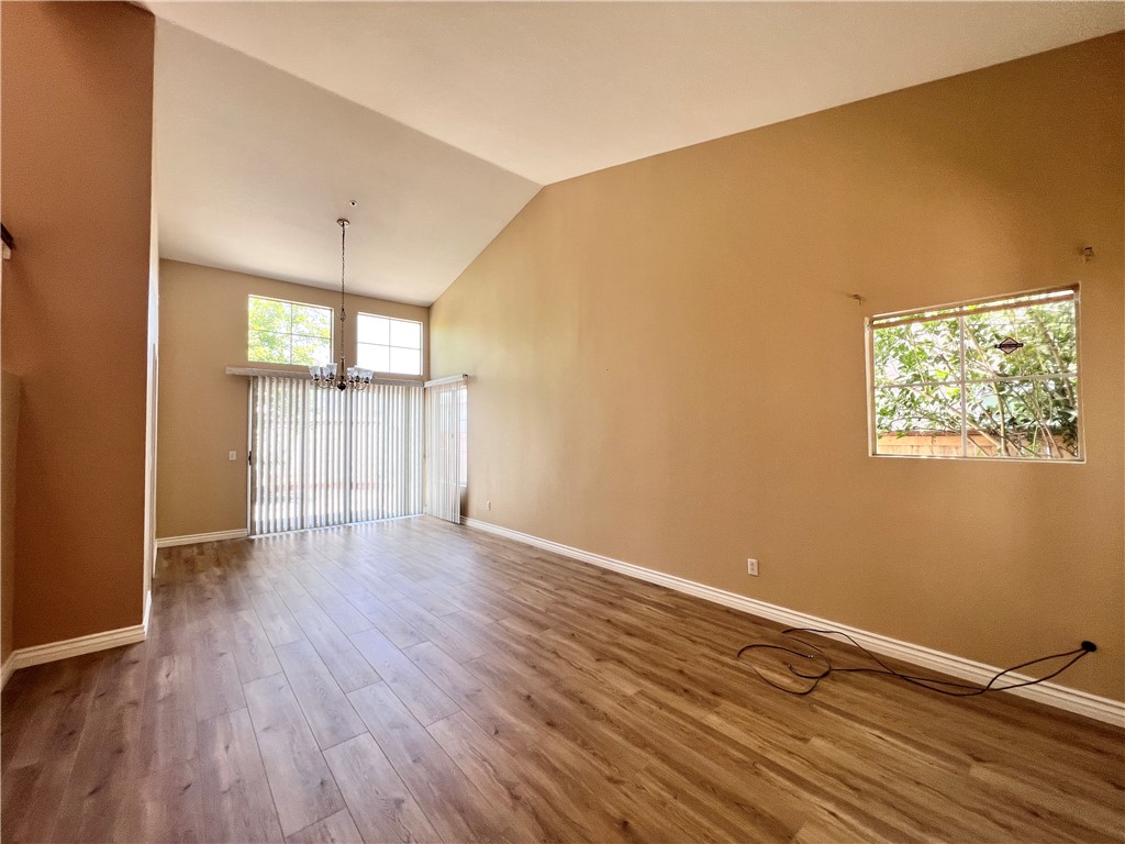 13764 Bay Fontana, CA 92336 - Photo 3 of 18 a view of an empty room with window and wooden floor