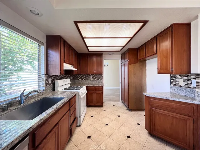 a kitchen with a sink a stove and a refrigerator