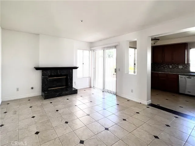a view of empty room with window and fireplace