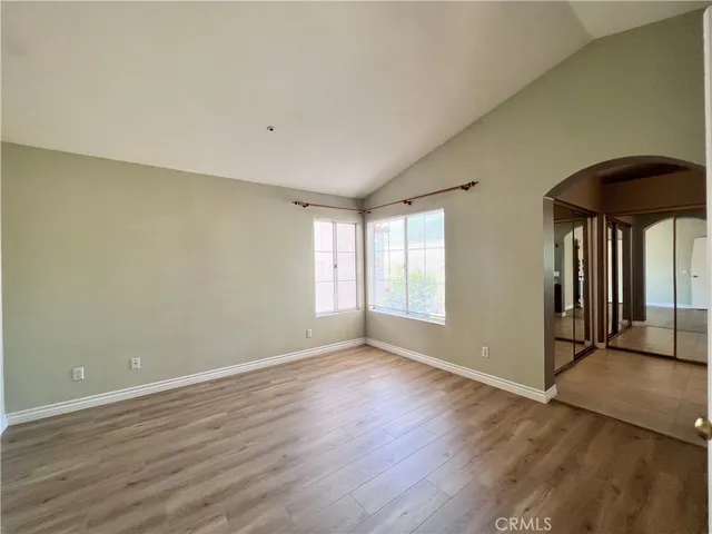 an empty room with wooden floor and a window