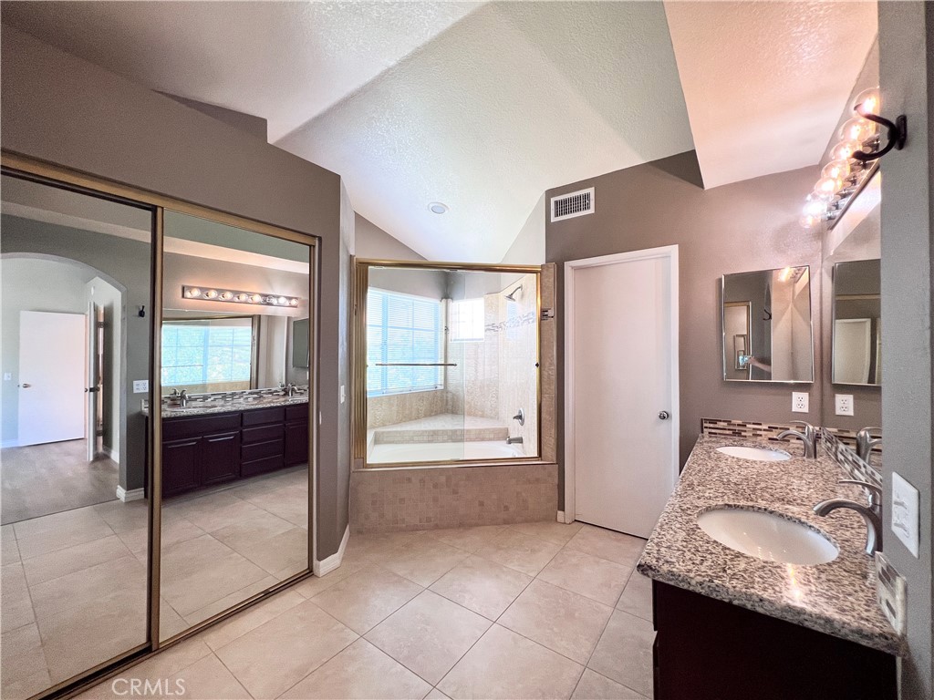 13764 Bay Fontana, CA 92336 - Photo 8 of 18 a bathroom with a granite countertop tub sink and mirror