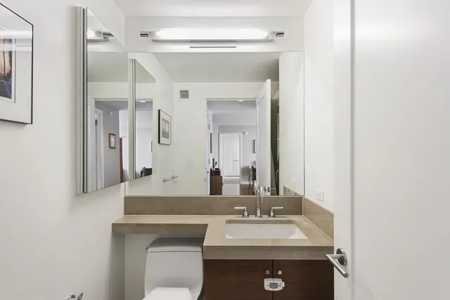 a bathroom with a sink vanity and a mirror