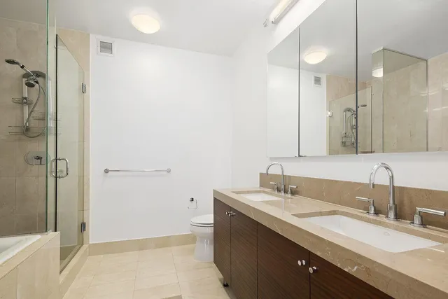 a bathroom with a granite countertop sink mirror and double