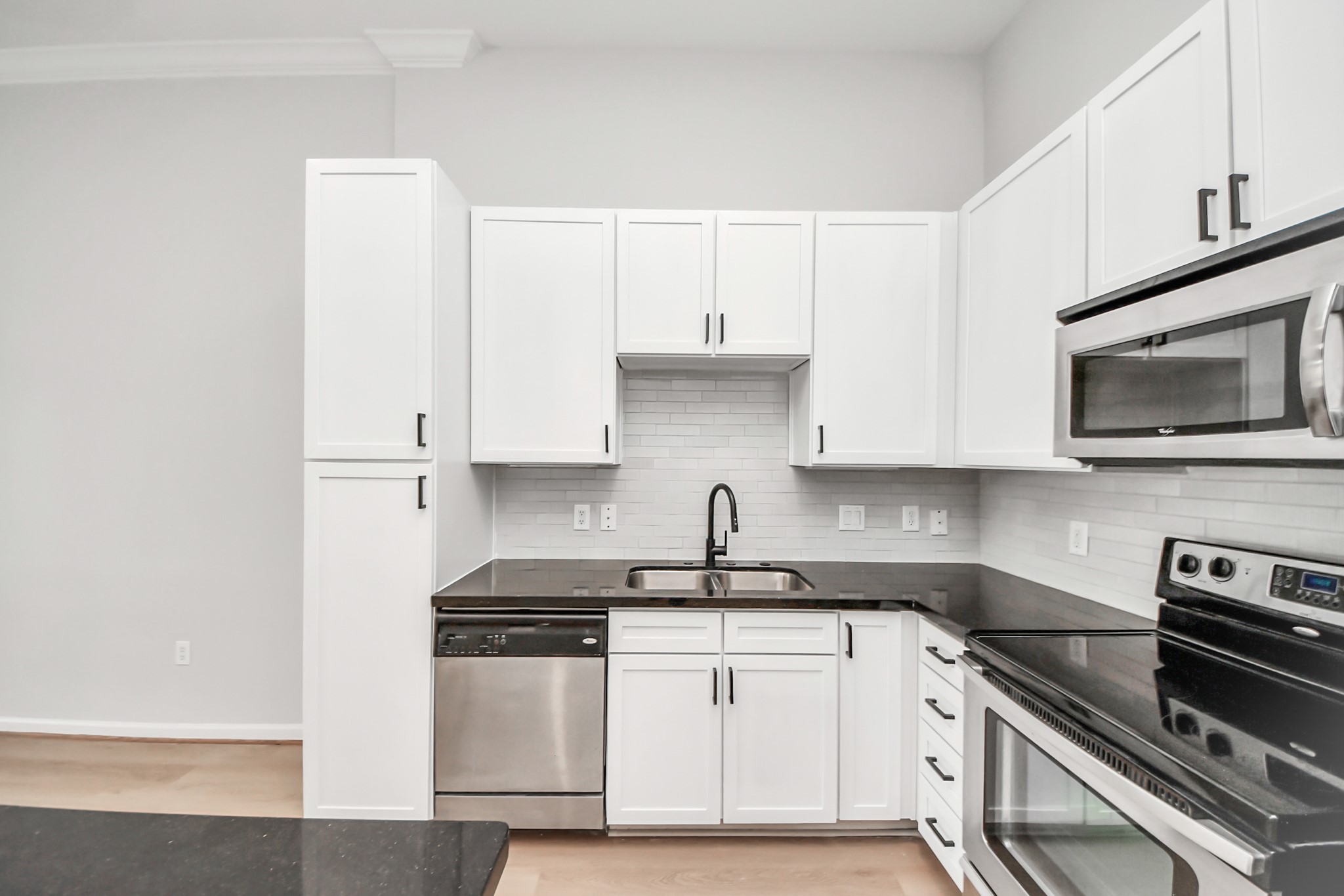 6363 San Felipe Street, Unit 562 Houston, TX 77057 - Photo 10 of 43 a kitchen with stainless steel appliances granite countertop a sink stove and microwave