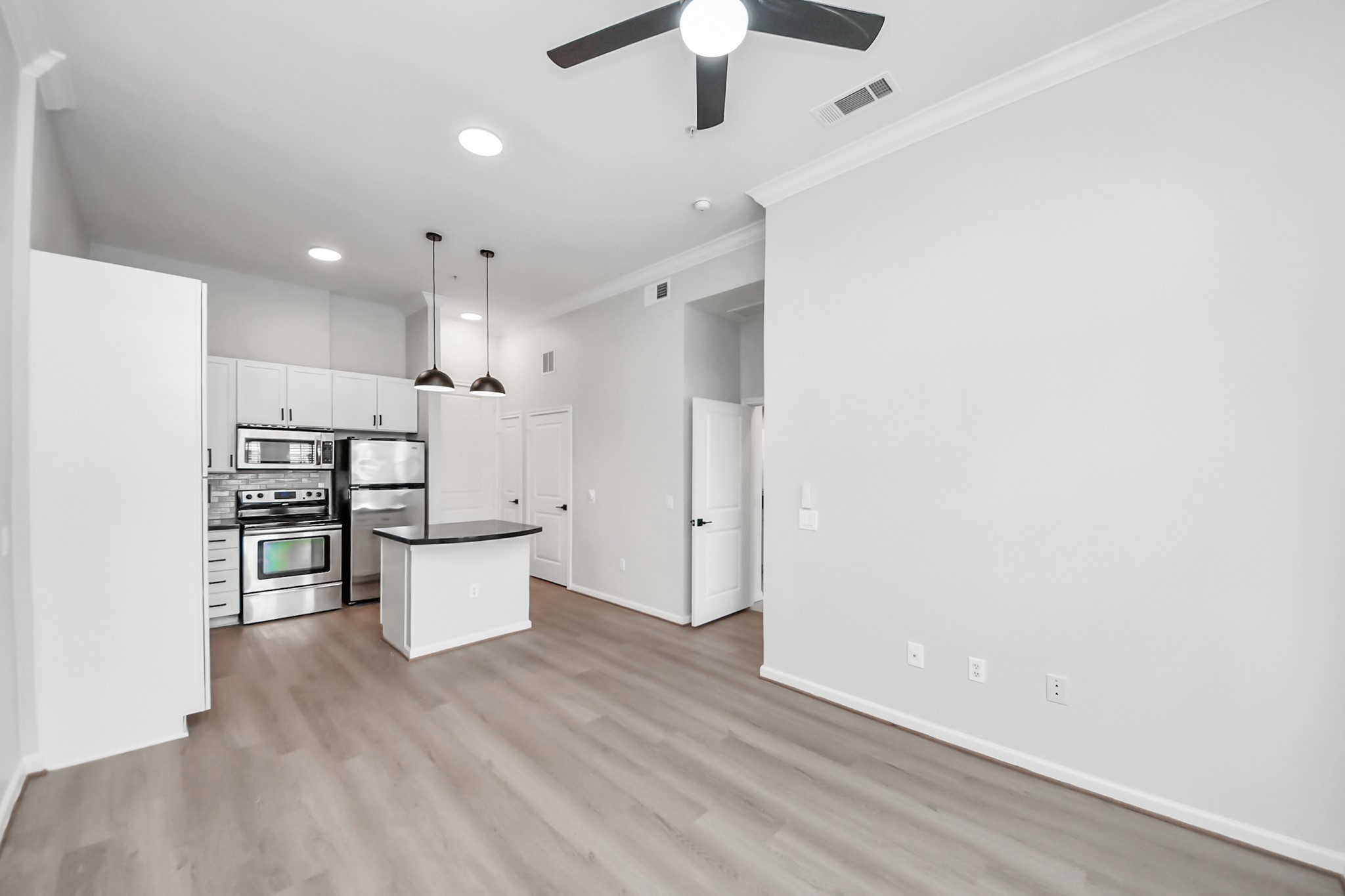 6363 San Felipe Street, Unit 562 Houston, TX 77057 - Photo 13 of 43 a kitchen with a refrigerator and white cabinets