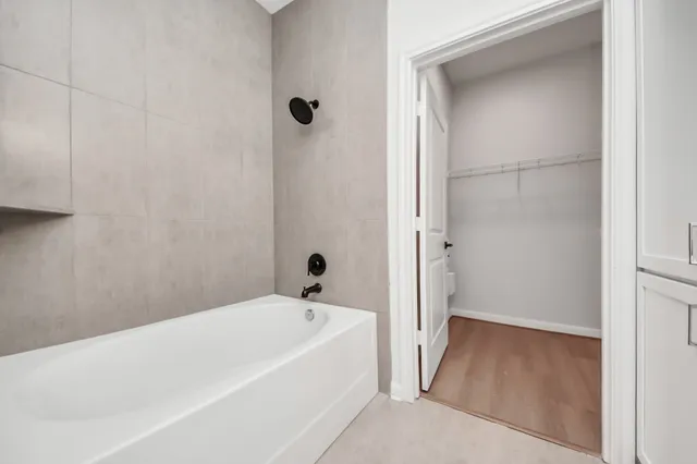 a bathroom with a tub and shower