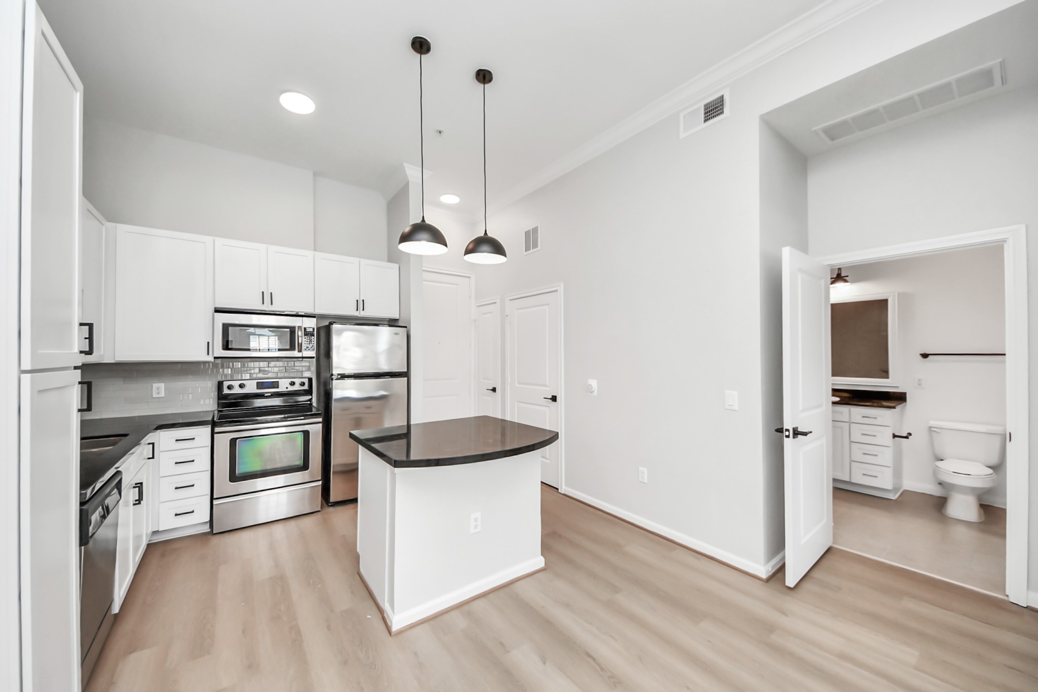 6363 San Felipe Street, Unit 562 Houston, TX 77057 - Photo 8 of 43 a kitchen with stainless steel appliances a stove a sink and a refrigerator