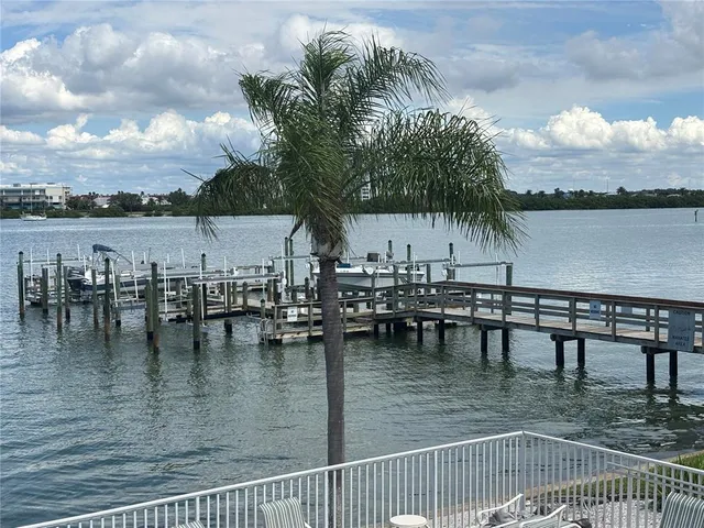 a view of roof deck with dining table and chairs