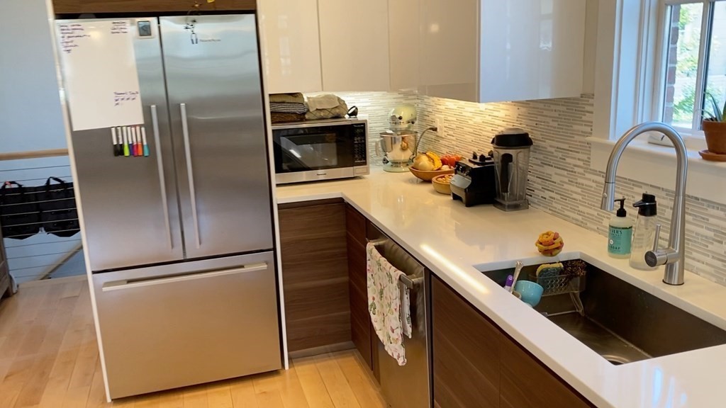 292 Beacon Street, Unit 1 2 Somerville, MA 02143 - Photo 19 of 27 a kitchen with stainless steel appliances granite countertop a refrigerator a sink and a stove