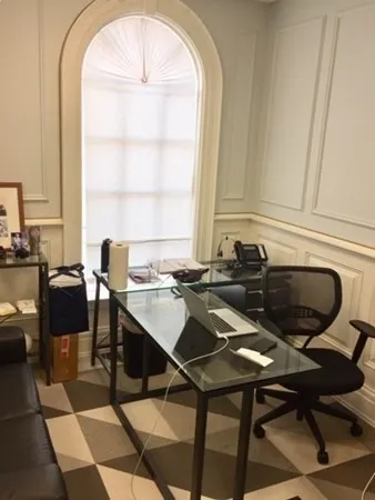 a view of a dining room with furniture and a window