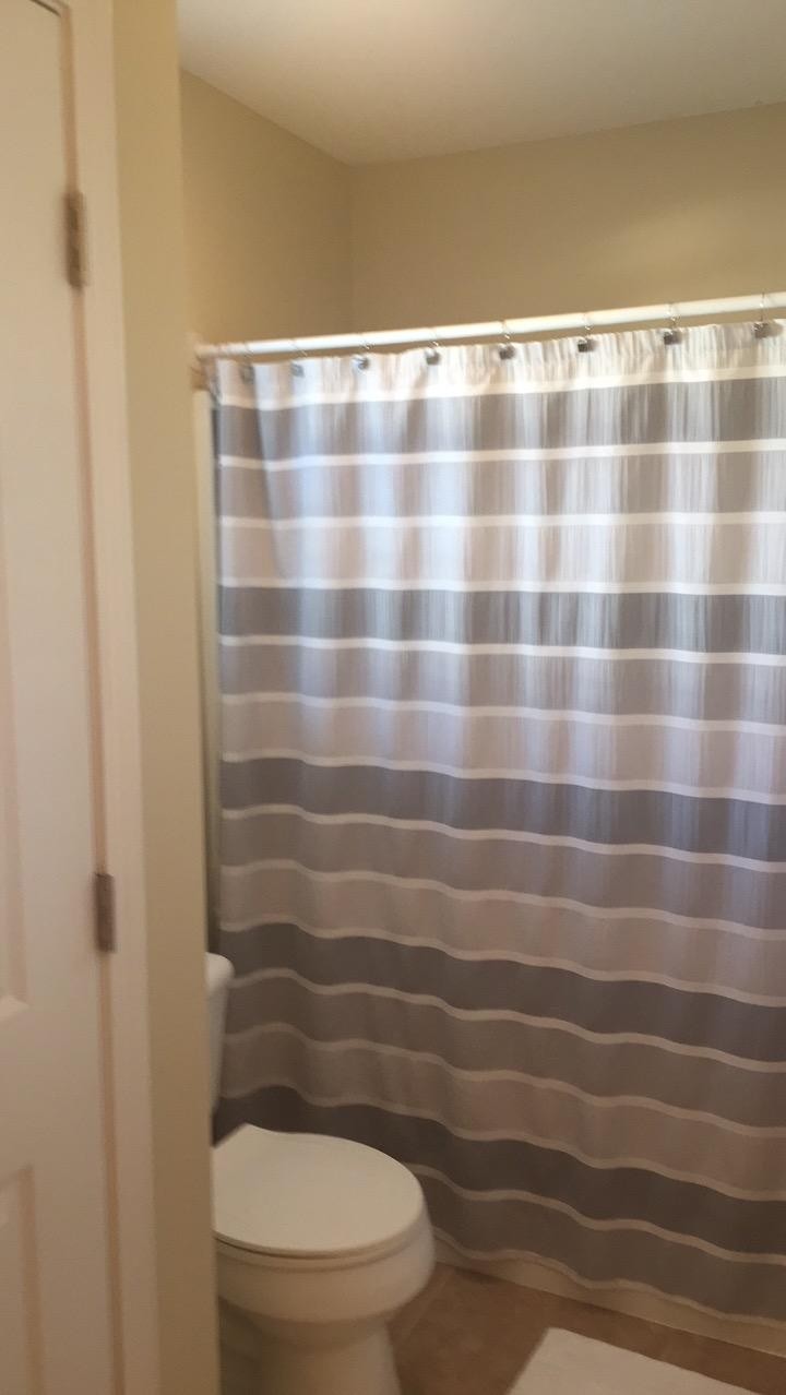7557 Gary White Road Corryton, TN 37721 - Photo 13 of 23 a bathroom with a toilet and a shower curtain