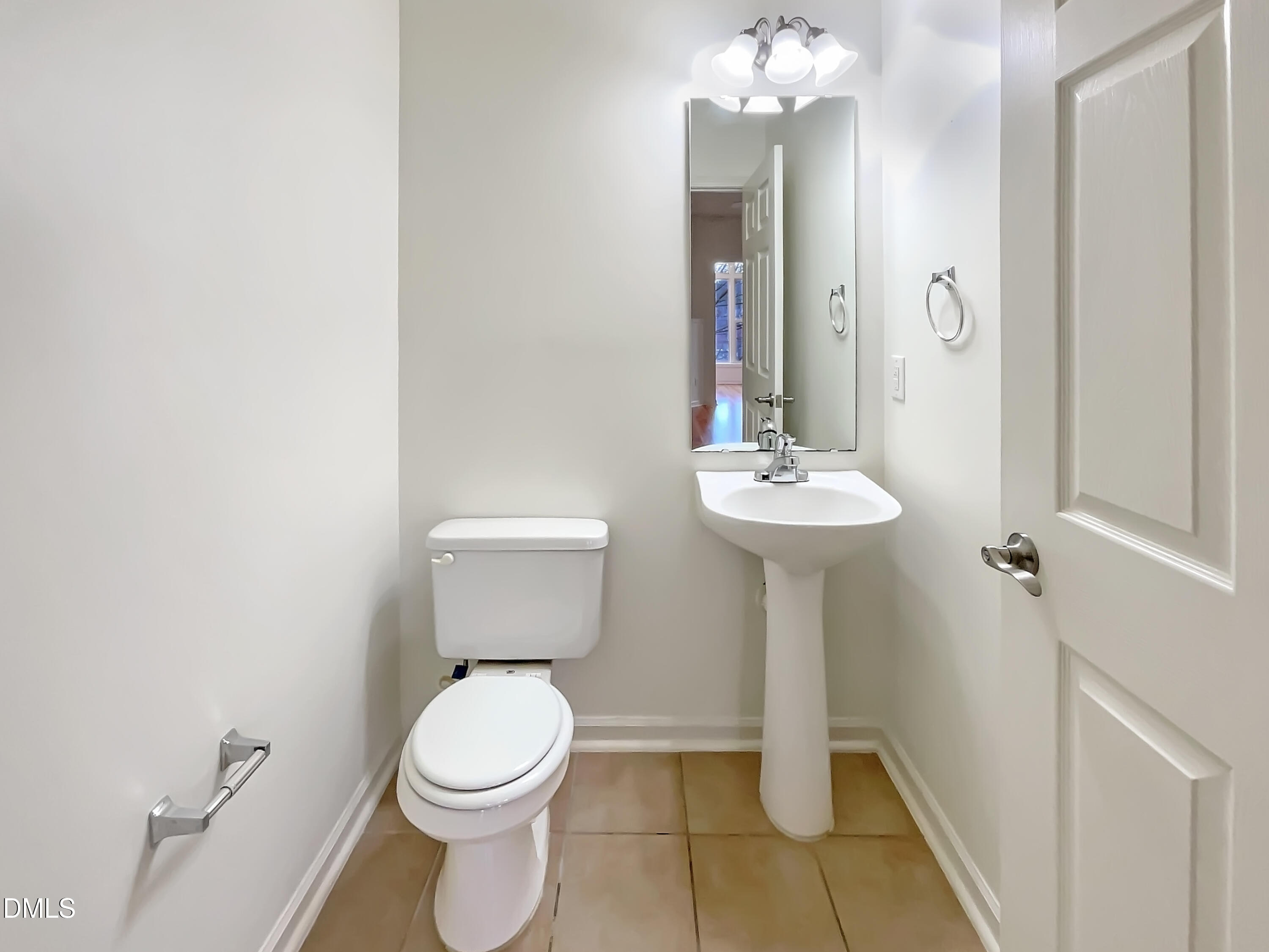 2501 Huntscroft Lane, Unit 203 Raleigh, NC 27617 - Photo 9 of 16 a bathroom with a toilet sink and mirror