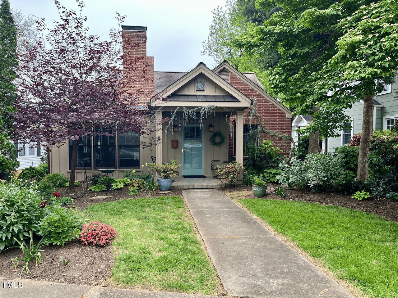 309 Perry Street Raleigh, NC 27608 - Photo 1 of 4 a front view of a house with garden