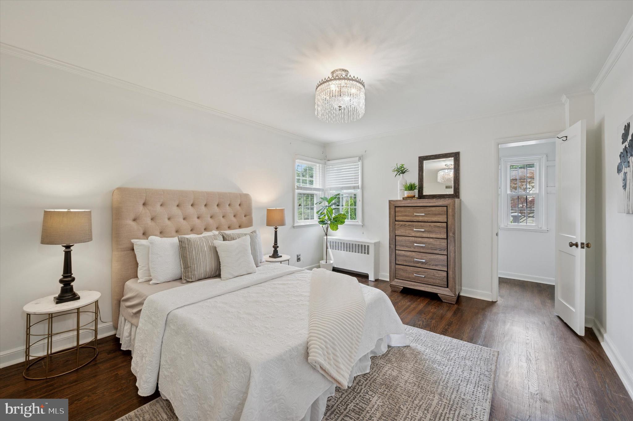 12 Rodney Road Bryn Mawr, PA 19010 - Photo 11 of 25 a bedroom with a bed and a chandelier