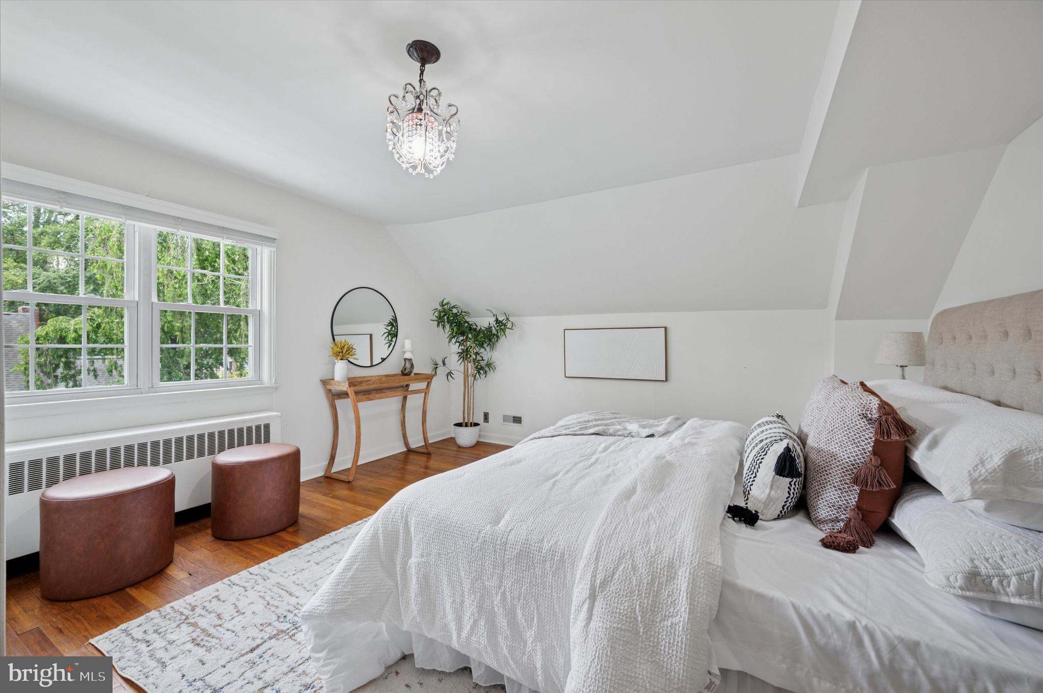 12 Rodney Road Bryn Mawr, PA 19010 - Photo 16 of 25 a bedroom with a bed and a chandelier