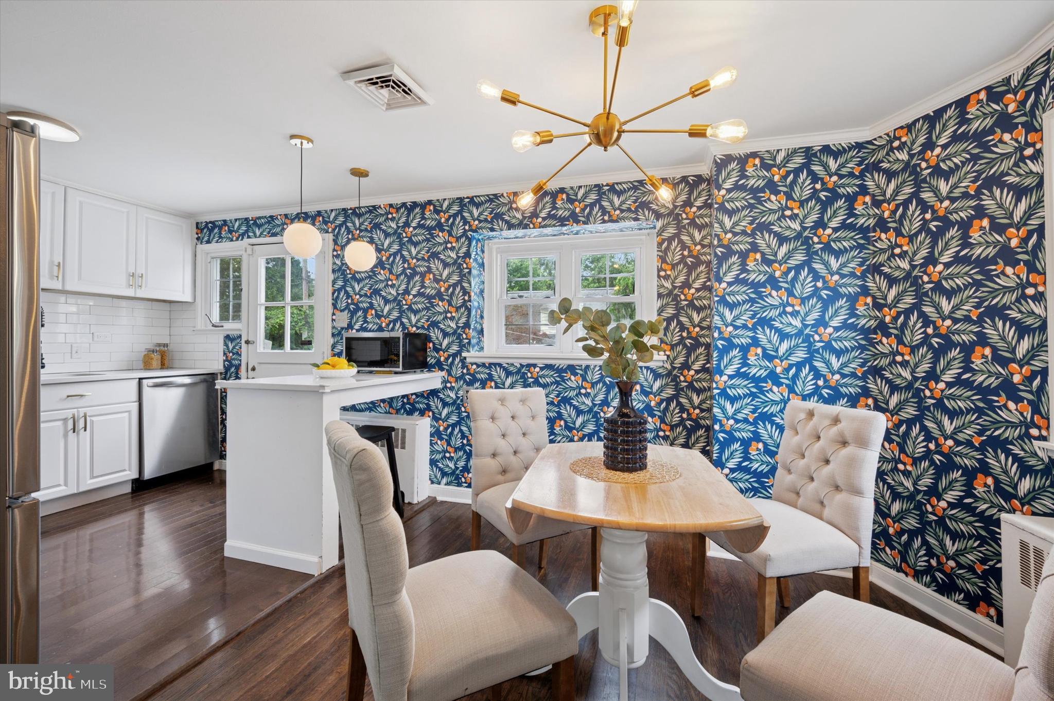 12 Rodney Road Bryn Mawr, PA 19010 - Photo 5 of 25 a kitchen with a dining table chairs stainless steel appliances and cabinets