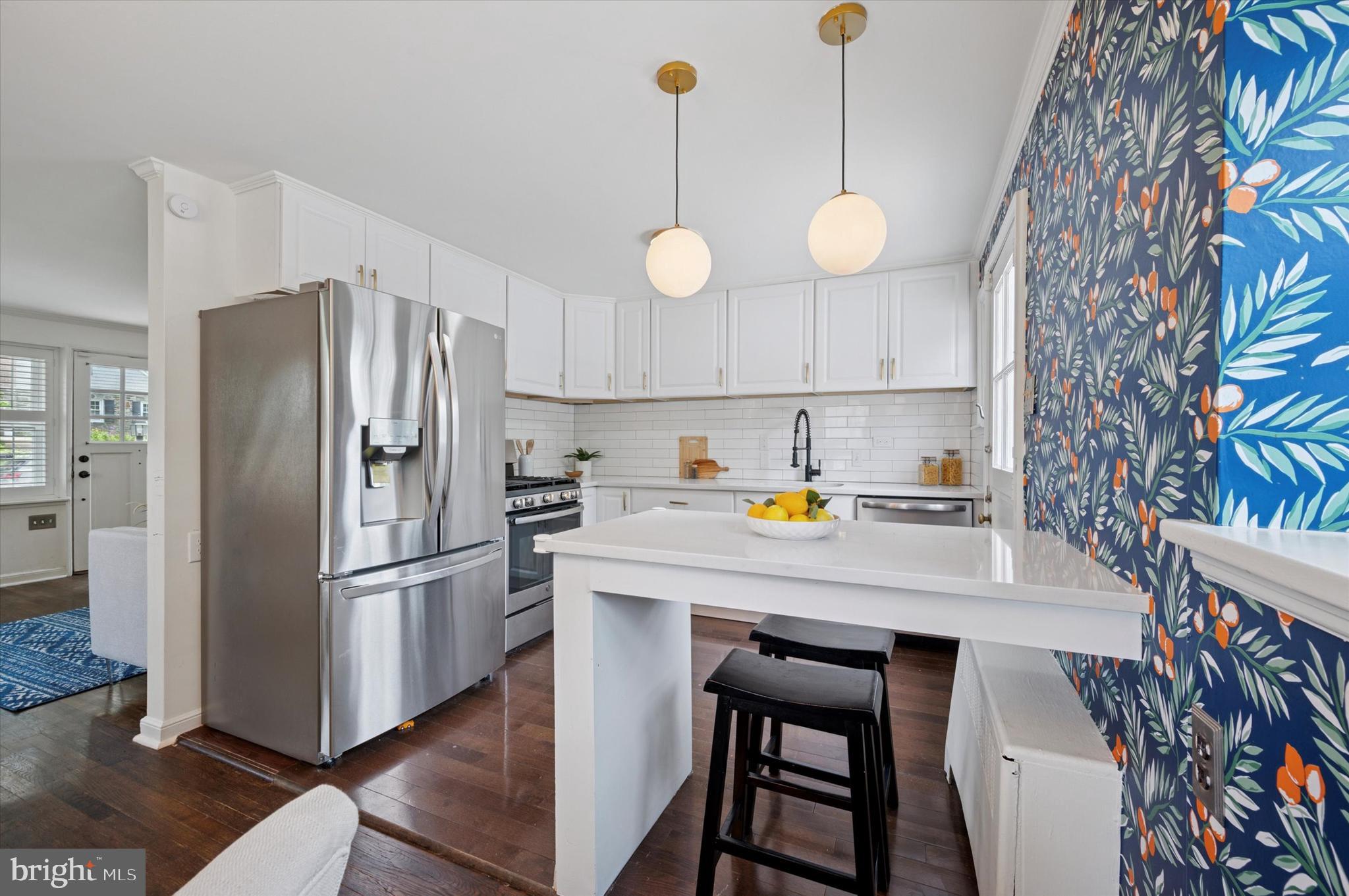 12 Rodney Road Bryn Mawr, PA 19010 - Photo 8 of 25 a kitchen with stainless steel appliances a stove a refrigerator and a chandelier
