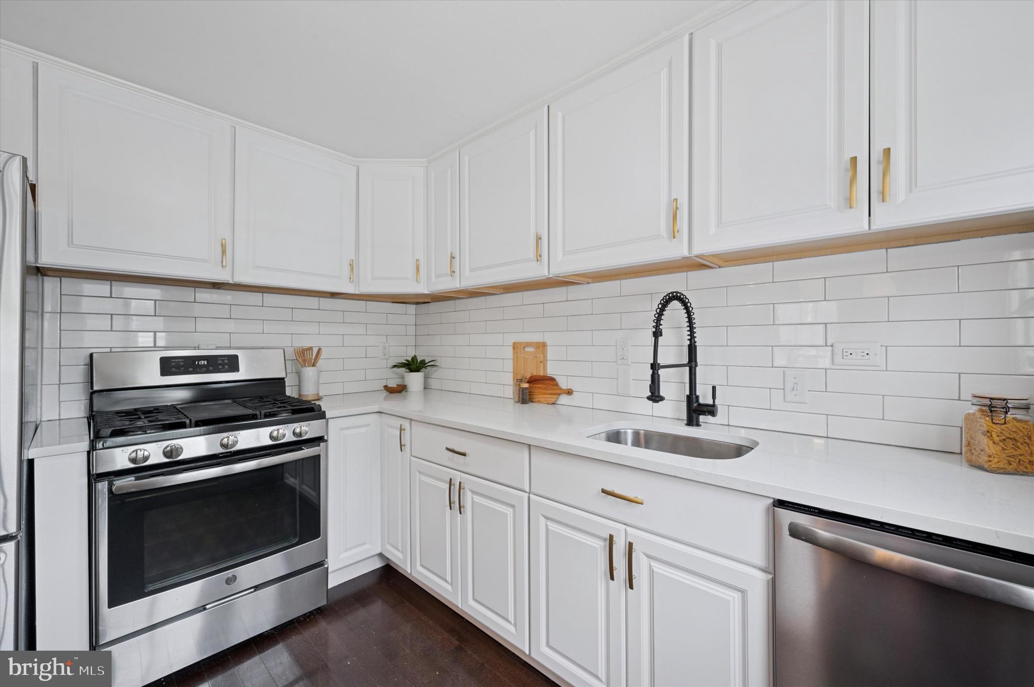 12 Rodney Road Bryn Mawr, PA 19010 - Photo 9 of 25 a kitchen with white cabinets and appliances