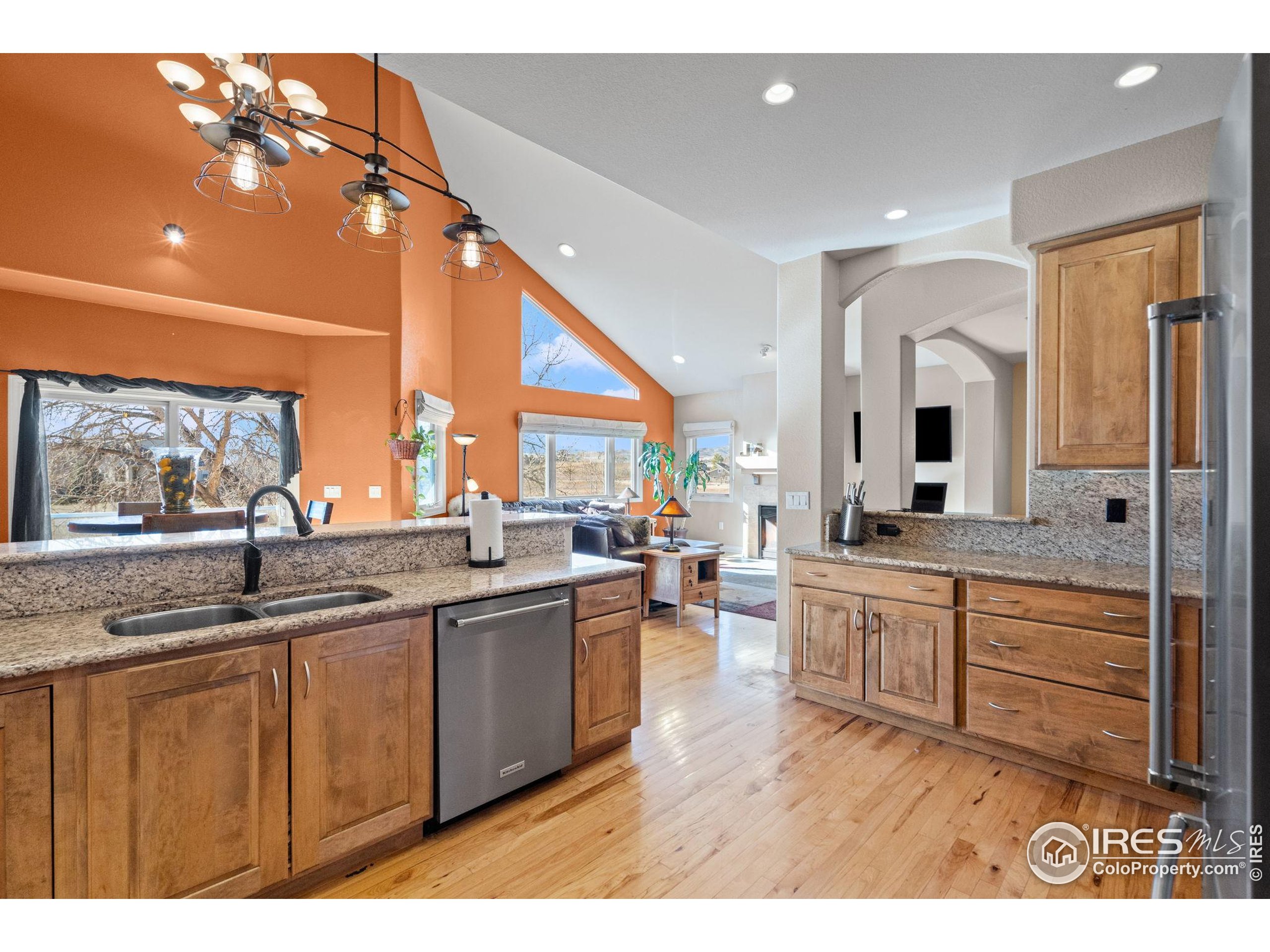 621 Roma Valley Drive Fort Collins, CO 80525 - Photo 17 of 50 a kitchen with stainless steel appliances granite countertop a sink and cabinets