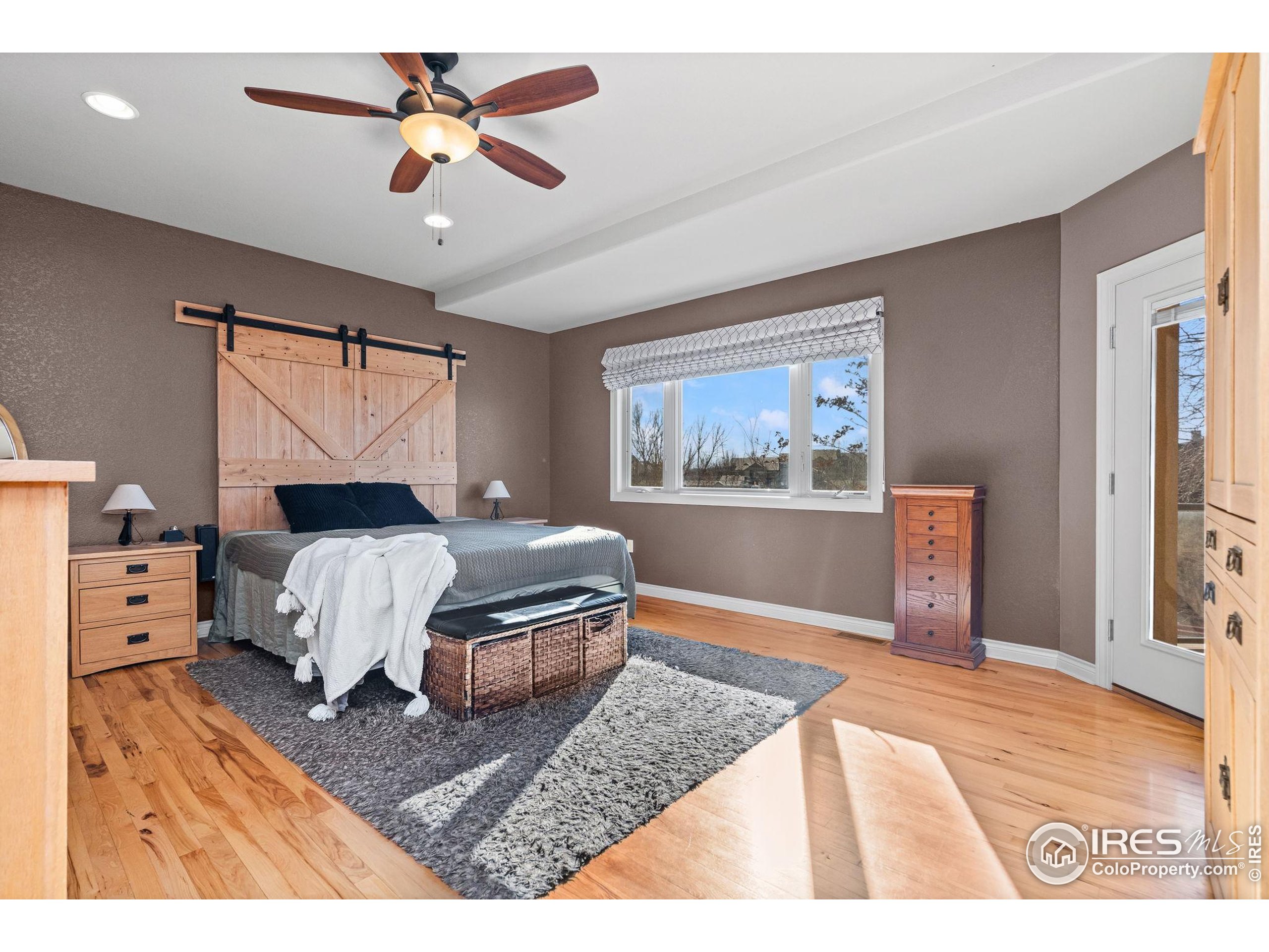 621 Roma Valley Drive Fort Collins, CO 80525 - Photo 18 of 50 a bedroom with a bed dresser and wooden floor