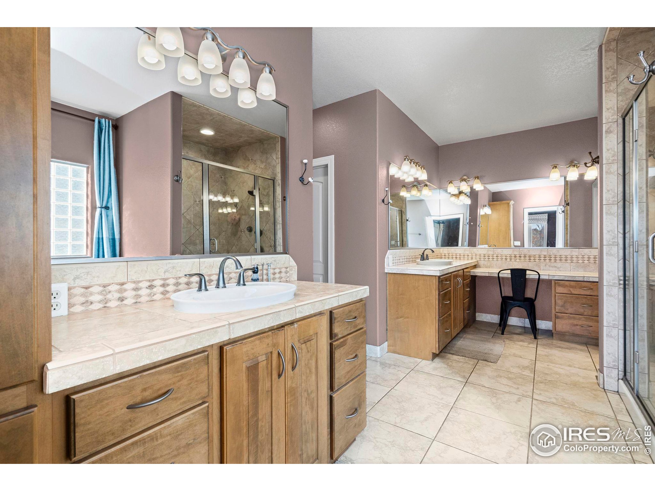 621 Roma Valley Drive Fort Collins, CO 80525 - Photo 20 of 50 a bathroom with a sink double vanity and a mirror