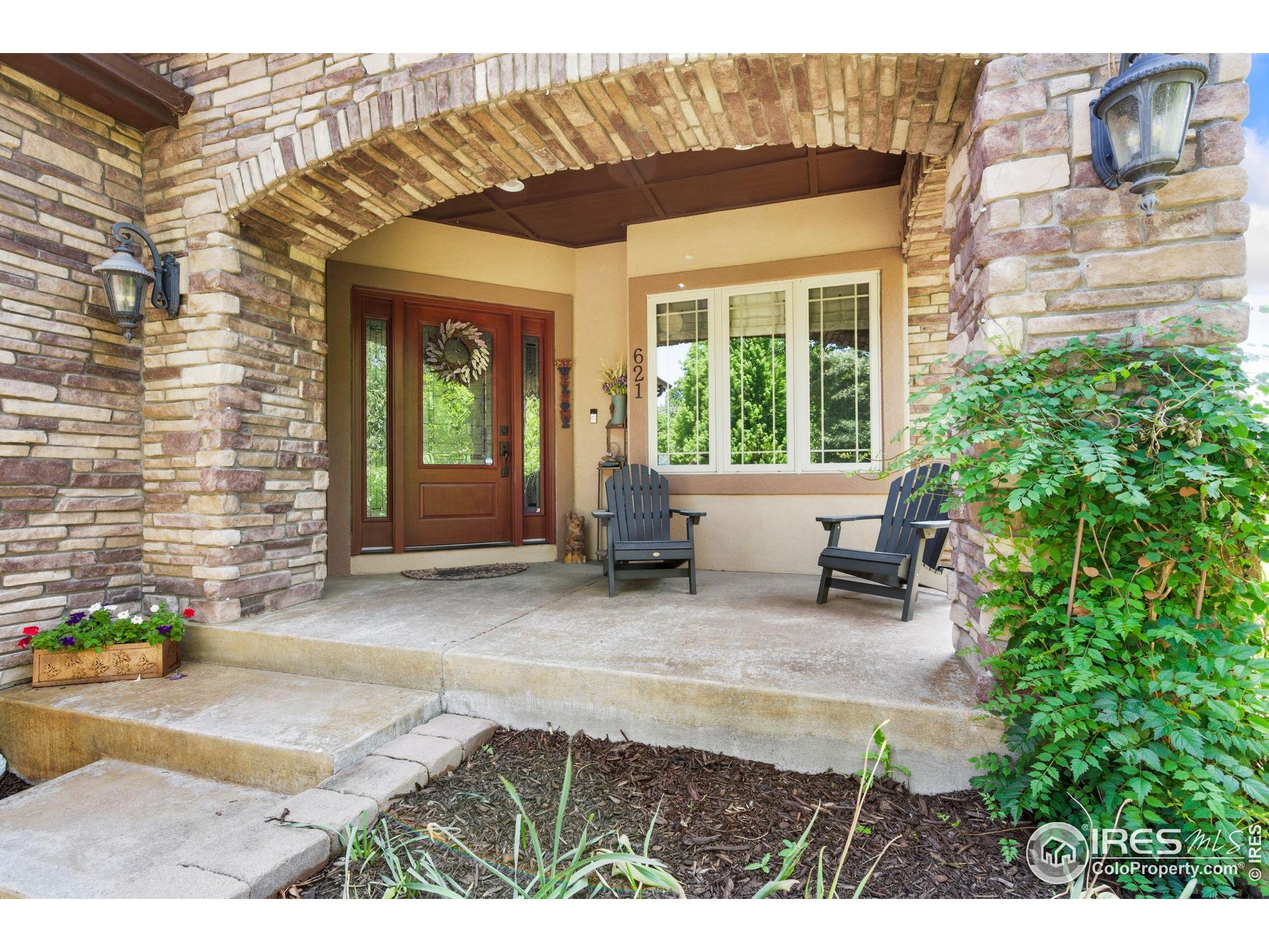 621 Roma Valley Drive Fort Collins, CO 80525 - Photo 2 of 50 a front view of a house with outdoor seating and plants